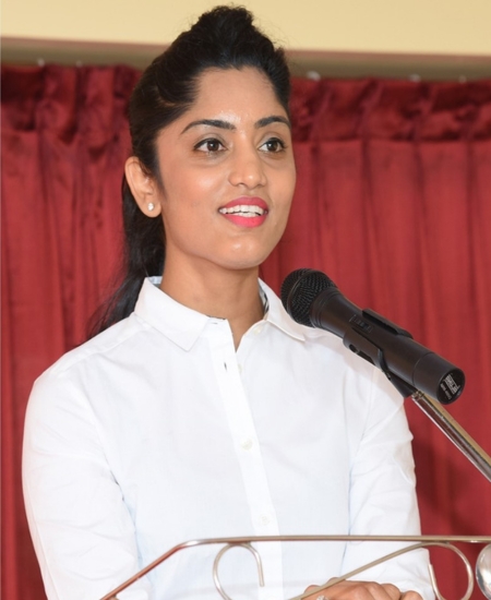 Mrs. Akshitha B, Associate Director at NewAge World School, addressing the audience and emphasizing the school's excellence as the Best International School in North Bangalore.